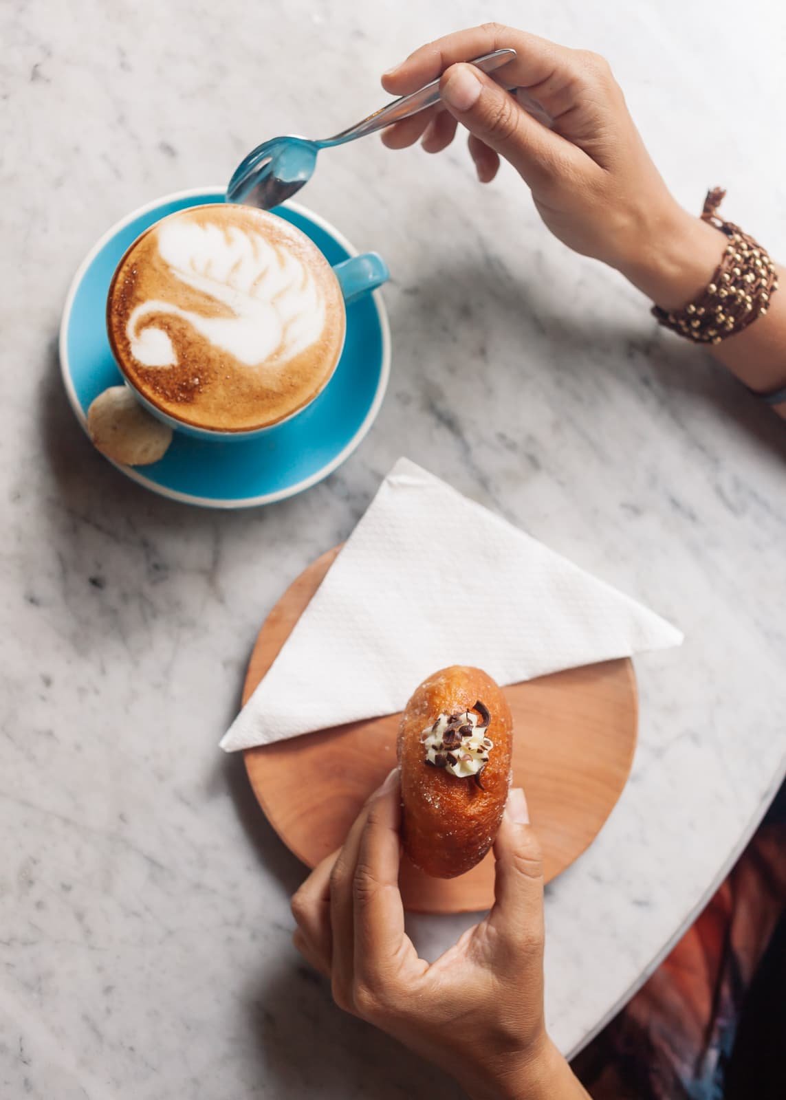 Fotografía profesional de un modelo con un café con leche con un donut